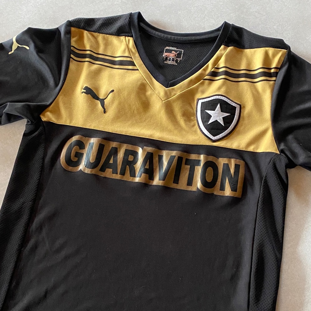 Puma Kids Black and Gold Guaraviton Soccer Jersey. Good condition, size small